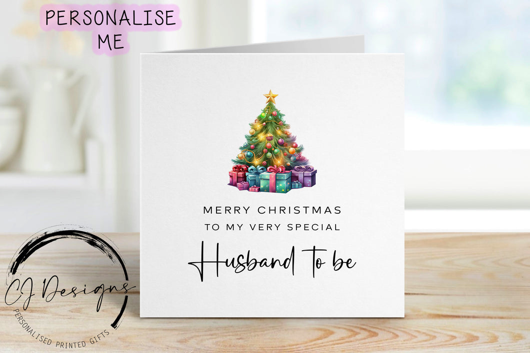 Husband to be chirstmas card with a picture of a colourful Christmas tree with gifts underneath