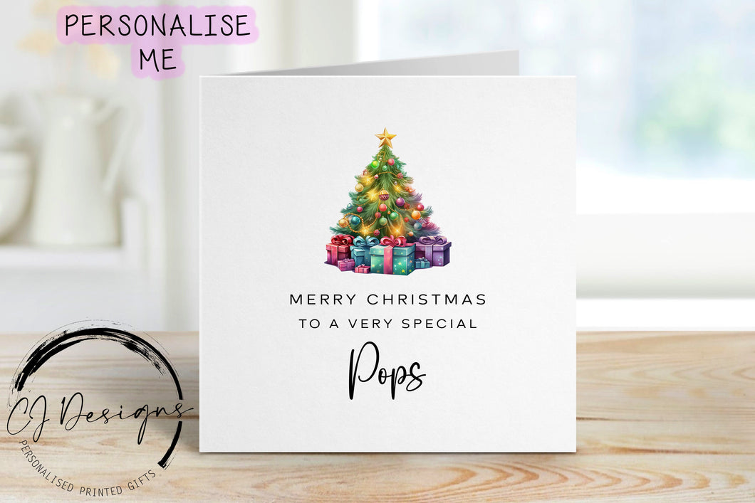 Pops chirstmas card with a picture of a colourful Christmas tree with gifts underneath