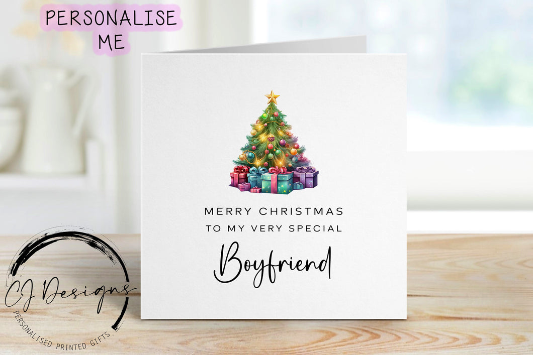 Boyfriend chirstmas card with a picture of a colourful Christmas tree with gifts underneath