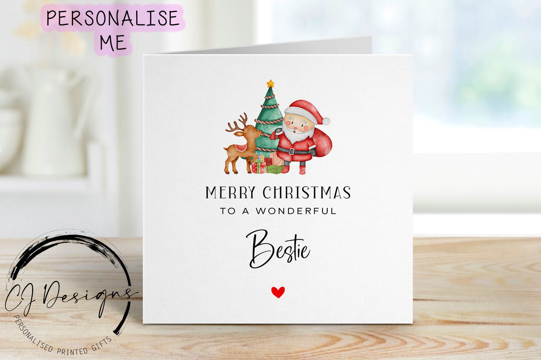 Bestie Christmas card wth a picture of santa and his reindeer stood in from of Christmas tree and gifts