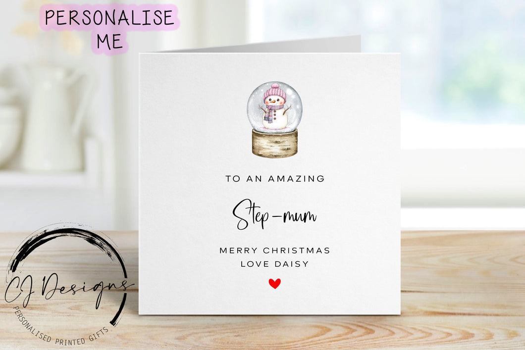Step-Mum personalised Christmas card with a picture of a snowglobe with a snowman inside wearing a pink hat and scarfe