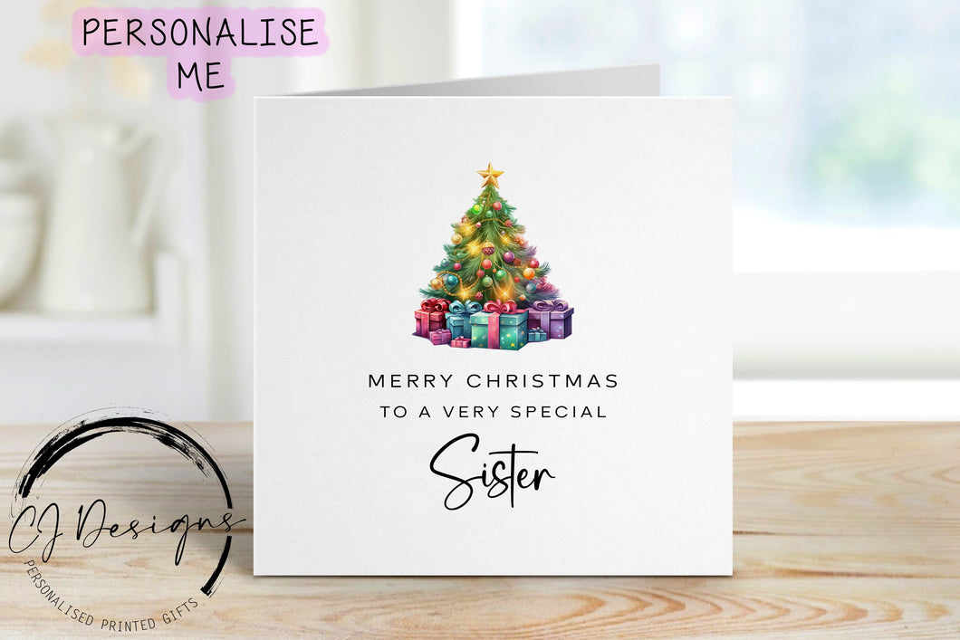 Sister chirstmas card with a picture of a colourful Christmas tree with gifts underneath