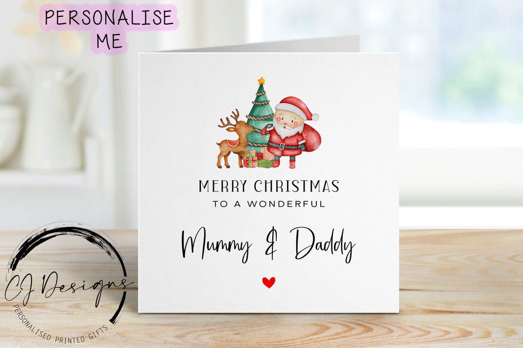 Mummy & Daddy Christmas card wth a picture of santa and his reindeer stood in from of Christmas tree and gifts