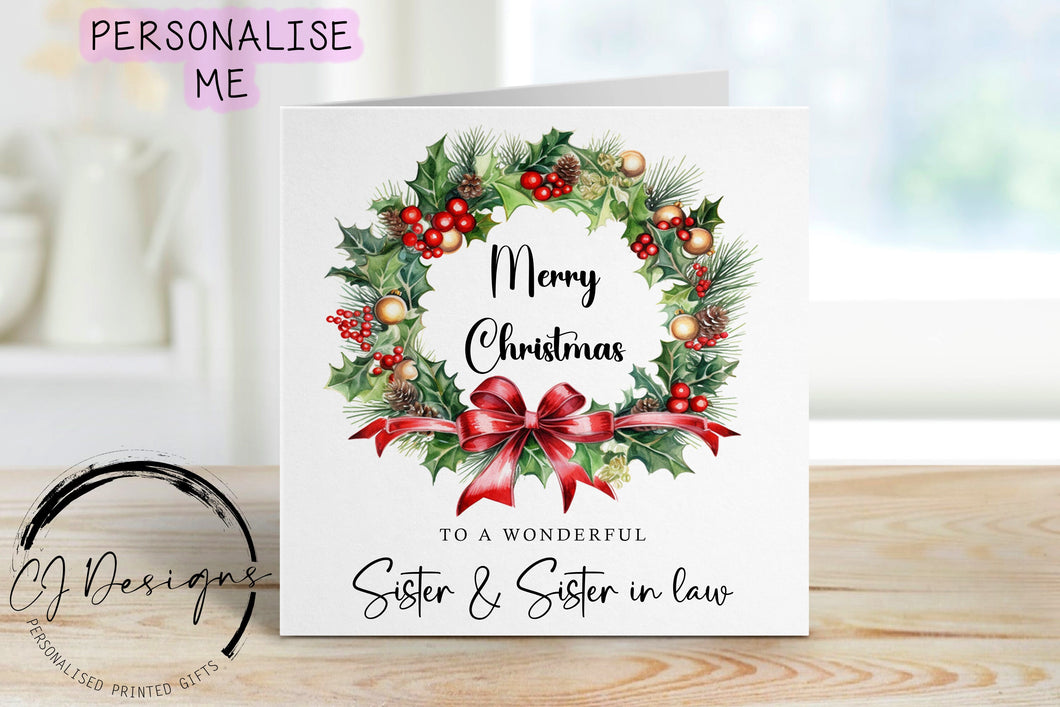 Sister & Sister in law Christmas Card with a picture of a christmas wreath with merry Christmas written in the center