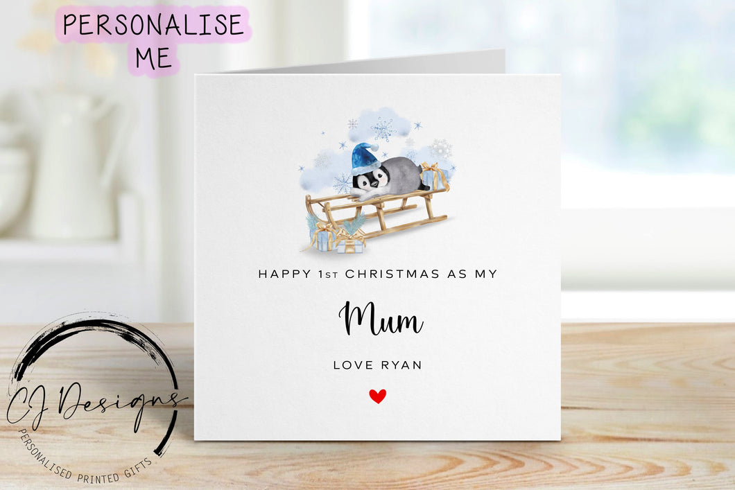 Little Boy First Christmas as my Mum personalised christmas card in a blue theme with picture of baby penguin wearing a blue christmas hat on a sledge