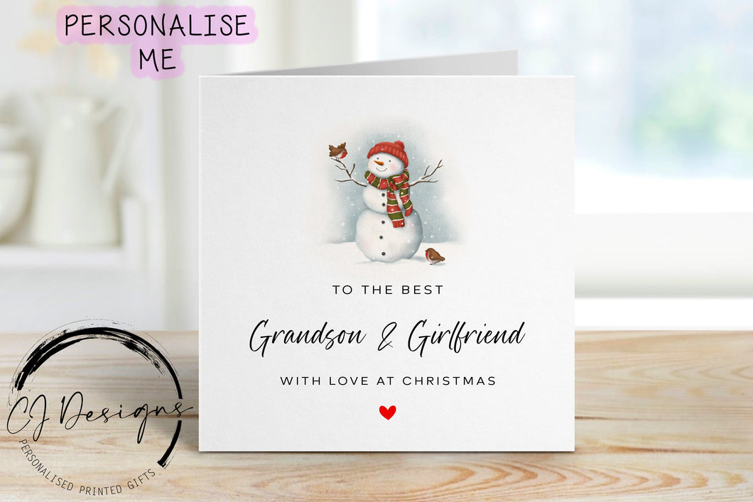 Best Grandson & Girlfriend Christmas card with a picture of a snowman with a robin purched on his hand and another robin by his feet