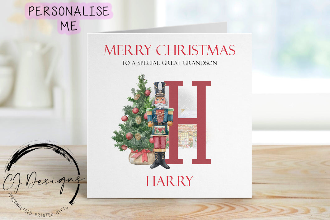Great Grandson personalised Christmas card with a nutcracker with Christmas Tree sstood next to a large red letter which depicts the first letter of your little